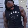 muscular man wearing power x purpose quick dry tank top for the gym.
