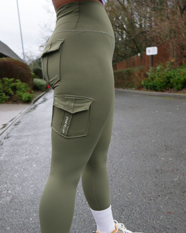 curvy girl wearing power x purpose cargo workout leggings in green which come in plus size xxl
