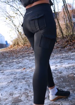 curvy girl wearing power x purpose womens cargo fitness workout leggings in black which come in plus size xxl
