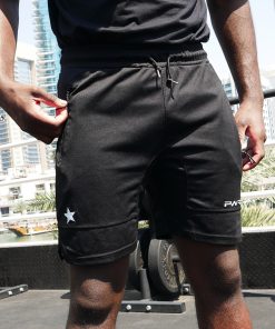 Boxer wearing power x purpose fitted sports shorts training at KO8 outdoor gym in Dubai marina.