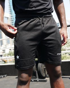 Boxer wearing power x purpose fitted sports shorts training at KO8 outdoor gym in Dubai marina.