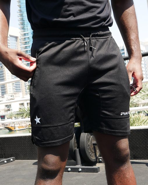 Boxer wearing power x purpose fitted sports shorts training at KO8 outdoor gym in Dubai marina.