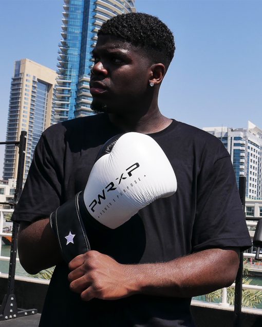 Boxer wearing power x purpose impact boxing gloves training at KO8 outdoor gym in Dubai marina.
