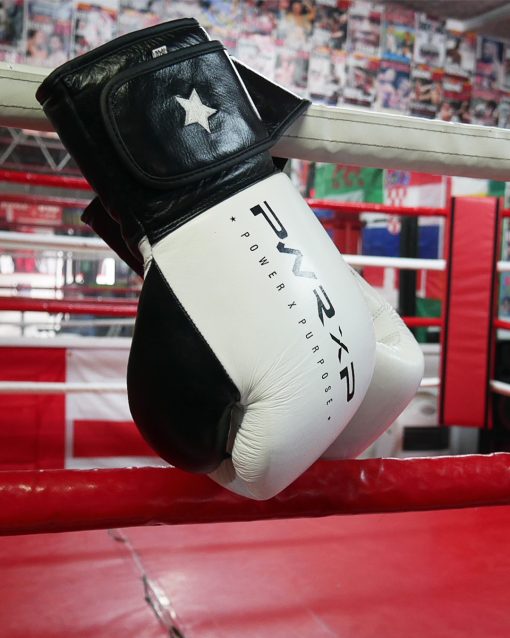 power x purpose impact boxing gloves hanging from ring at connellys gym birmingham.