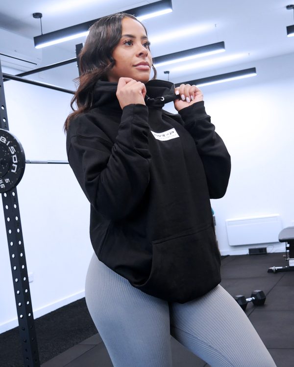 pretty girl at the gym squat rack wearing power x purpose love yourself hoodie