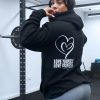 pretty girl at the gym squat rack wearing power x purpose love yourself hoodie