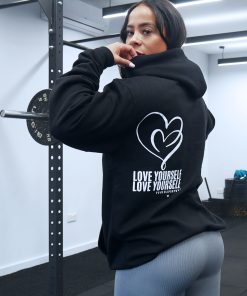 pretty girl at the gym squat rack wearing power x purpose love yourself hoodie